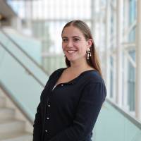 Woman posing on library stairs, smiling